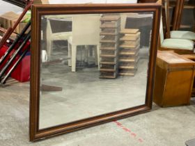 A large mahogany framed bevelled wall mirror. 136x105cm