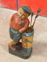 A large wooden golfing figure. 76cm