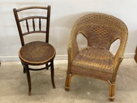 An early 20th century Thonet Bentwood chair with pokerwork seat and a vintage wicker armchair.