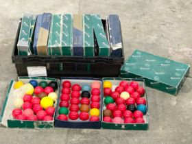 A large collection of Aramith snooker balls in boxes.