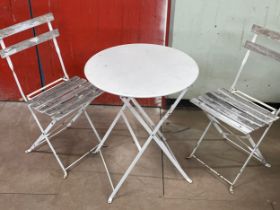A folding garden table and 2 chairs