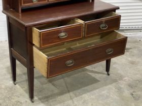 An Edwardian inlaid mahogany dressing chest. 107x48x157cm