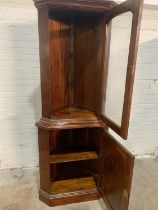 A mahogany corner cabinet.