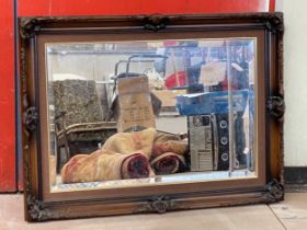 A large ornate framed mirror 95x69cm