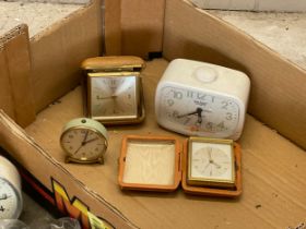 A box lot. A collection of new Amber glass and brass handles, 2 stone bottles, vintage clocks