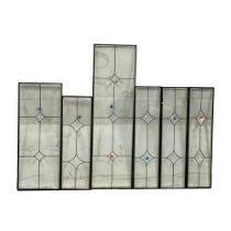A set of 6 bevelled glass panels, largest 33x113cm