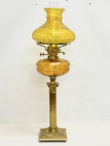 A large Victorian style double burner oil lamp with Amber Glass bowl, brass Corinthian style