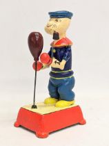 A cast iron mechanical Popeye toy. 20cm