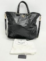 A ladies Prada ‘Vitello’ leather handbag and cover.