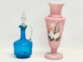 A large late Victorian hand painted glass vase with a late Victorian blue glass claret jug with