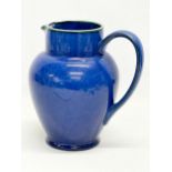 A Denby glazed pottery water jug. 20x20cm