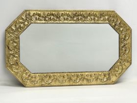 A vintage ornate brass framed mirror. 73.5x43cm
