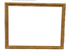 A large ornate gilt framed bevelled mirror. 114x88cm