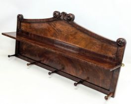 An early Victorian mahogany wall mounted hat and coat rack with shelf and rosette mouldings.