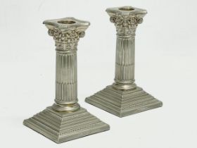 A pair of Walker & Hall silver plated candlesticks with Corinthian style columns. 9x9x17cm