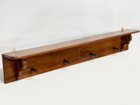 A Victorian mahogany wall hanging hat and coat rack. 118x13x18cm.