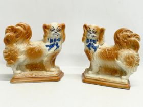 A pair of early 20th century Staffordshire pottery dogs. 21x19cm