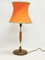 A tall Mid Century teak table lamp. 69cm