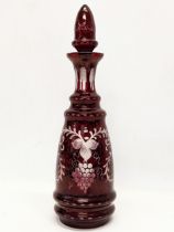 A large late 19th century Bohemian etched Ruby Glass decanter. 37cm