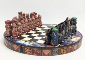 A painted medieval style chess set. Board measures 26cm