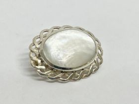 A silver and Mother of Pearl brooch.