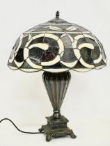 A large Tiffany style table lamp. Shade measures 52x30cm. Base 48cm.