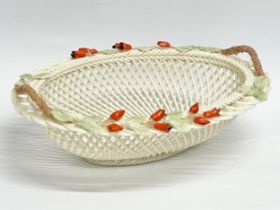 A Belleek pottery woven basket. 21x16x7cm