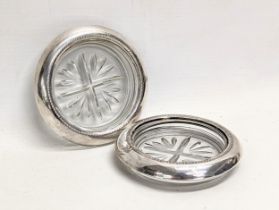 A pair of F. B. Rogers silver and glass coasters. 10cm