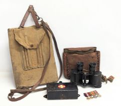 A sundry lot containing a military map folder, field binoculars, military field first aid case,