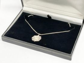 A silver spider webb necklace.
