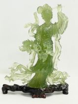 A 20th century Chinese Jadeite figure on wooden stand. 17x23cm