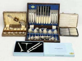 A collection of vintage cutlery sets and a Wedgwood bar set in box. A silver plated cutlery set in