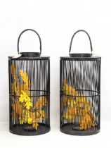 A pair of large candle holders in the form of birdcages. 73cm