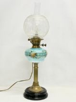 A large Victorian double burner electrified oil lamp with hand painted glass bowl and brass