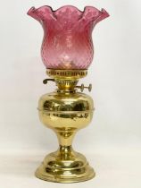 A vintage brass double burner oil lamp with Ruby Glass shade. 42.5cm