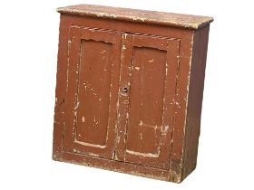 A Victorian pine 2 door cupboard with original paint. 72x31x78cm