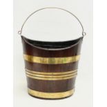 A George III brass bound mahogany peat bucket with original liner. Circa 1800. 37x27x37cm