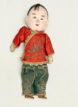 An early 20th century Chinese doll with silk embroidered clothing. Circa 1900-1920. 24cm