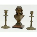 A 19th century spelter bust on stand with a pair of late 19th century brass candlesticks. Bust