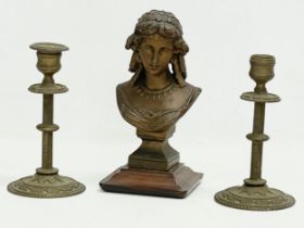 A 19th century spelter bust on stand with a pair of late 19th century brass candlesticks. Bust