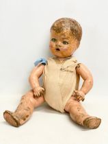 An early 20th century doll. 35cm