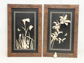 A pair of early 20th century Japanese lacquered panels with carved bone motif in wooden frames.