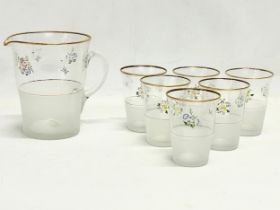 A 1970’s Mid Century drinks set. A set of 6 juice glasses and matching jug.