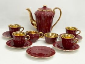 A 12 piece ‘Royal Victoria’ burgundy and gilt porcelain coffee set by Wade.