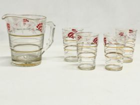 A 1970’s Mid Century drinks set. 4 juice glasses and matching jug.