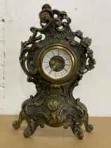 An ornate brass mantle clock. 36cm