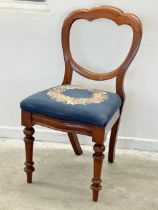 A Victorian mahogany balloon back side chair with tapestry seat.