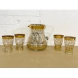 A 1960’s Mid Century gilt glass drinks set. A jug and 4 matching glasses. Jug 20x19cm. Glasses 11.