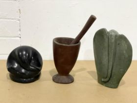 2 stone ornaments and a mortar and pestle.