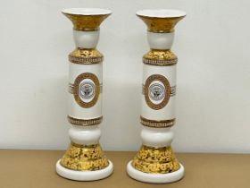 A pair of large Versace style porcelain candleholders. 33cm